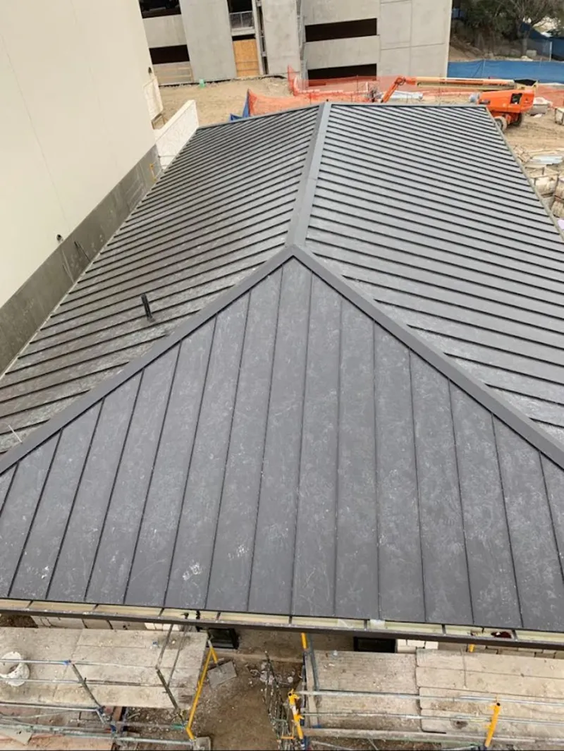 Commercial metal roof construction with crane equipment in Mount Olive