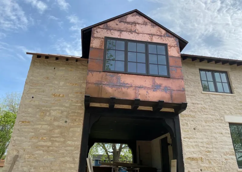 Copper metal panel facade on a stone building for Roof Repair in Mount Olive
